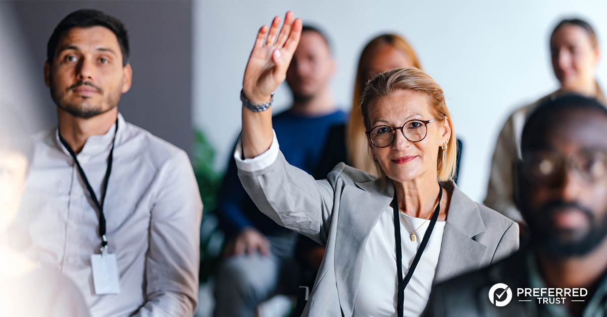 Business owner looking out window with an open sign in the window
